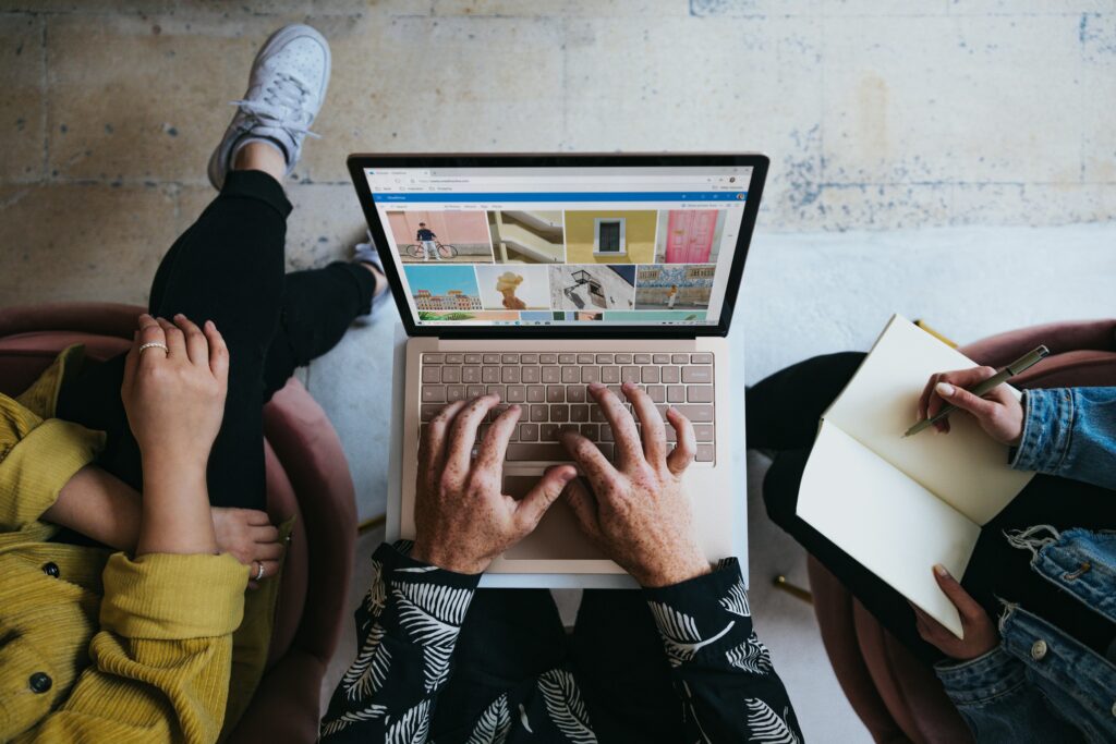 A generic image from above, of a person's hands on a laptop keyboard.